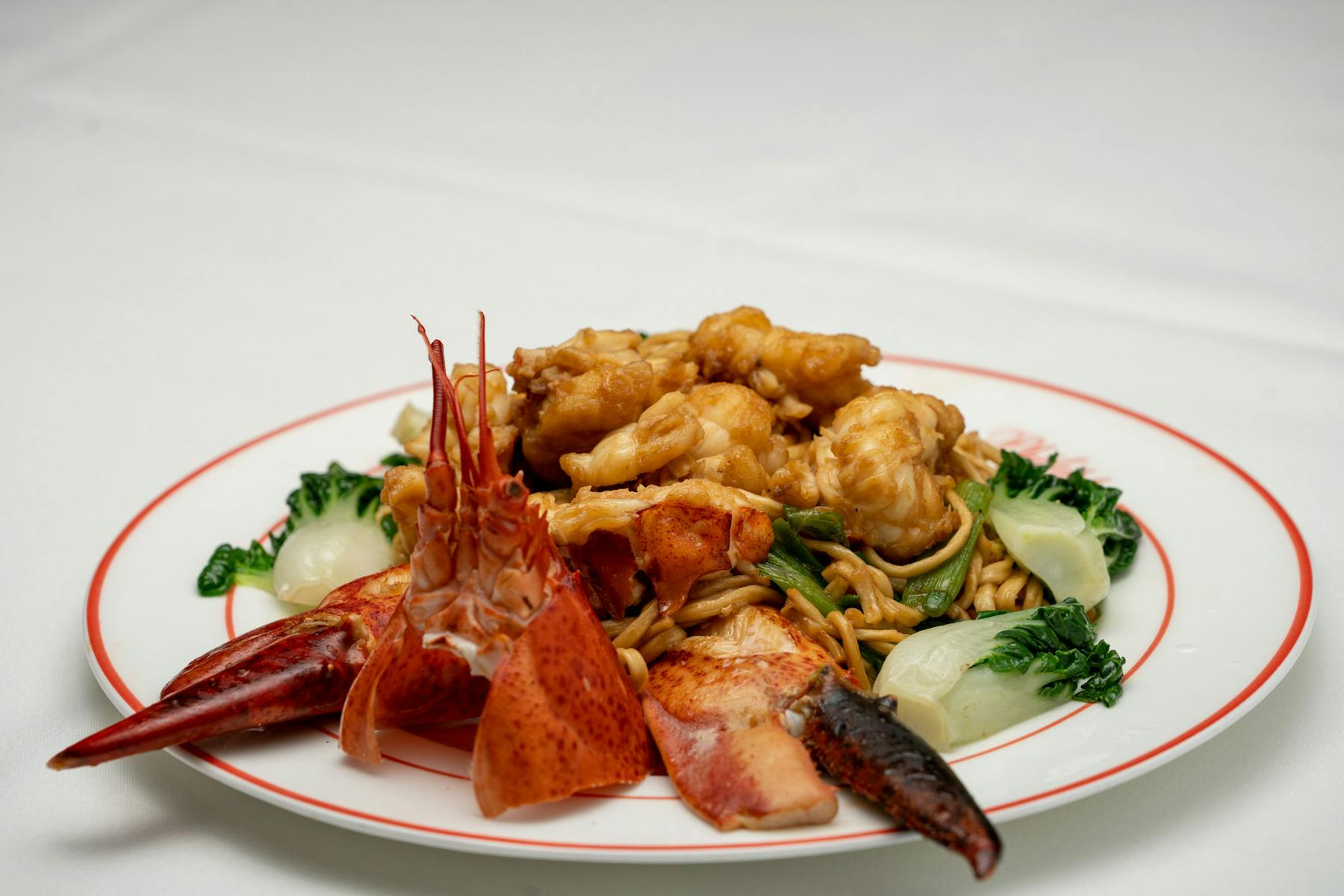 a white plate topped with meat and vegetables